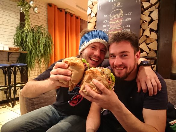 two men eating burgers